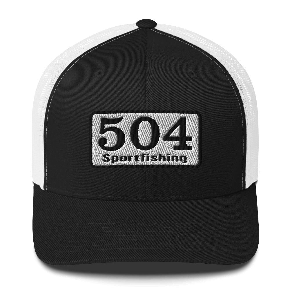 A Black and White trucker Cap with"504 Sportfishing" written on the front.