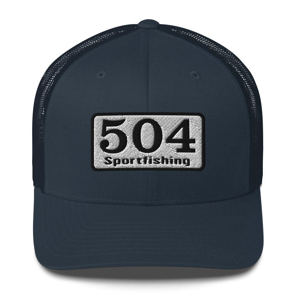 A Navy trucker Cap with"504 Sportfishing" written on the front.