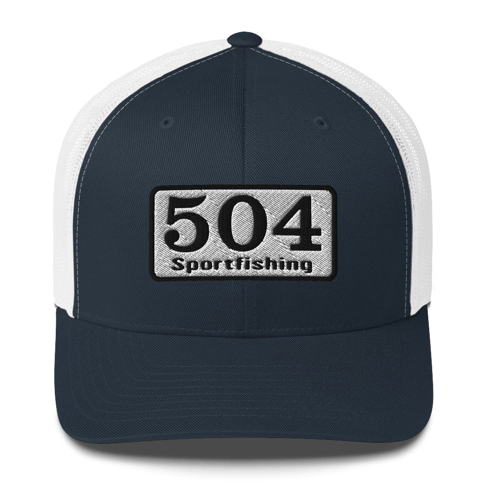 A Navy and White trucker Cap with"504 Sportfishing" written on the front.