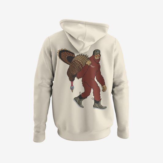 Beige hoodie with a graphic of a person in a red suit carrying a large bird on the back, on a white background.